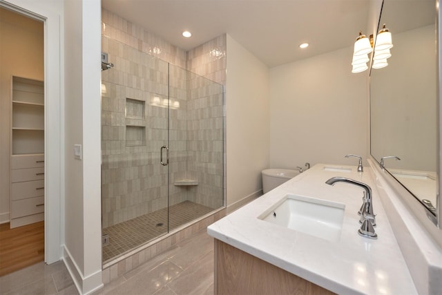 bathroom with vanity, toilet, tile patterned flooring, and a shower with door