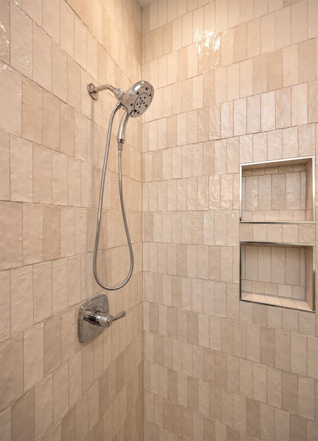 bathroom with a tile shower