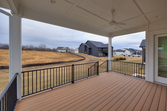 deck featuring ceiling fan and a lawn