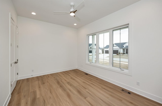 unfurnished room featuring light hardwood / wood-style floors and ceiling fan