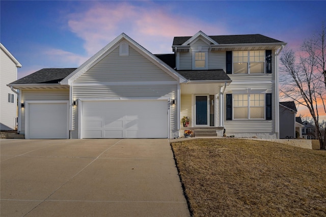 view of front facade featuring a garage and a lawn