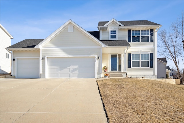 view of front of property with a garage and a front yard