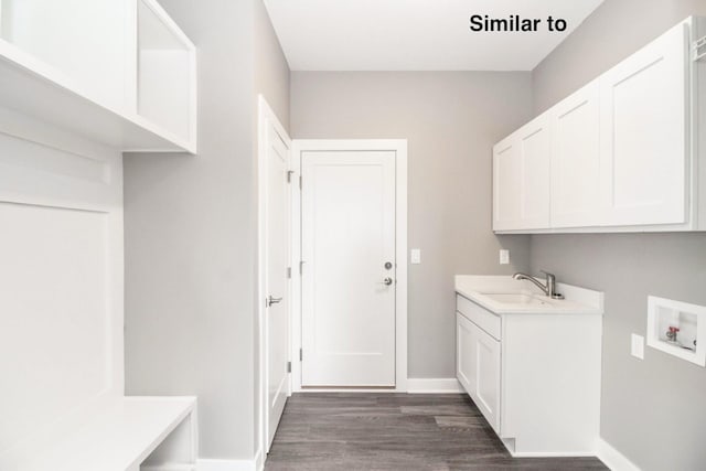 laundry room with cabinets, sink, washer hookup, and dark hardwood / wood-style flooring