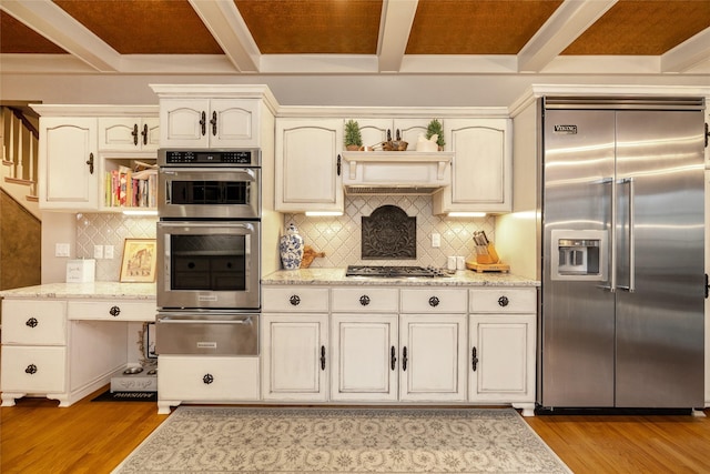 kitchen with stainless steel appliances, light wood-type flooring, and beam ceiling