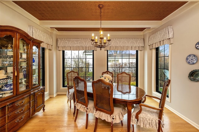 dining area featuring a notable chandelier, beam ceiling, and light hardwood / wood-style flooring