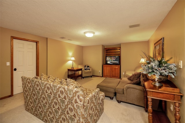 living room with light colored carpet and a textured ceiling