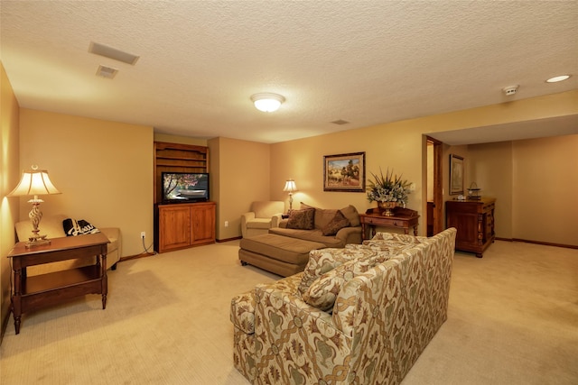 carpeted living room with a textured ceiling