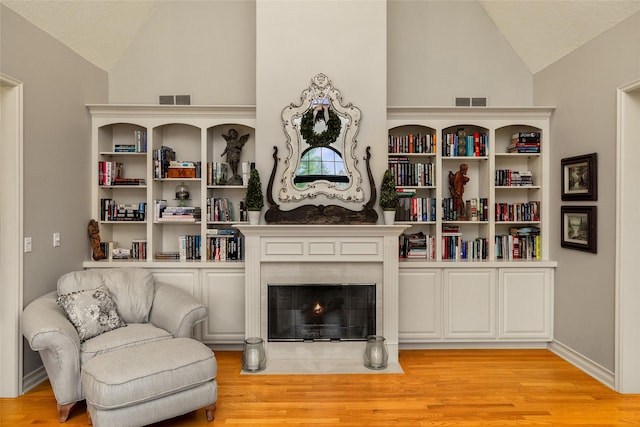 sitting room featuring vaulted ceiling and light wood-type flooring