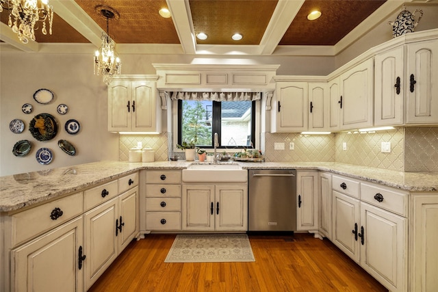 kitchen featuring sink, hardwood / wood-style floors, hanging light fixtures, and dishwasher