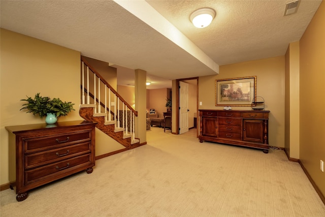 interior space with light colored carpet and a textured ceiling