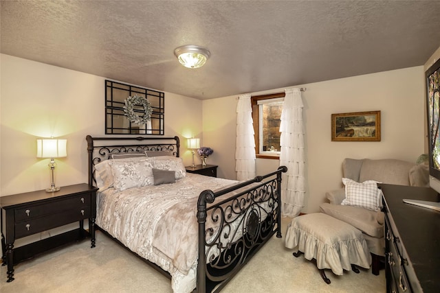 carpeted bedroom featuring a textured ceiling