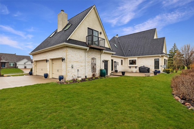 back of property with a balcony, a yard, and a patio area