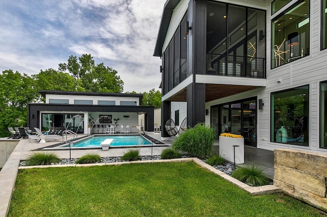 view of swimming pool with a yard and a patio