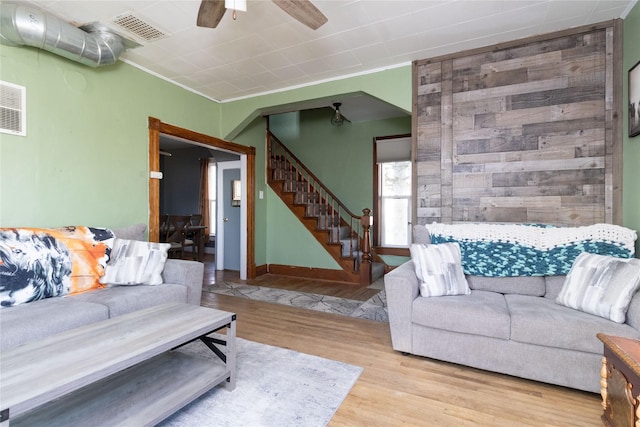 living room with ceiling fan and light wood-type flooring