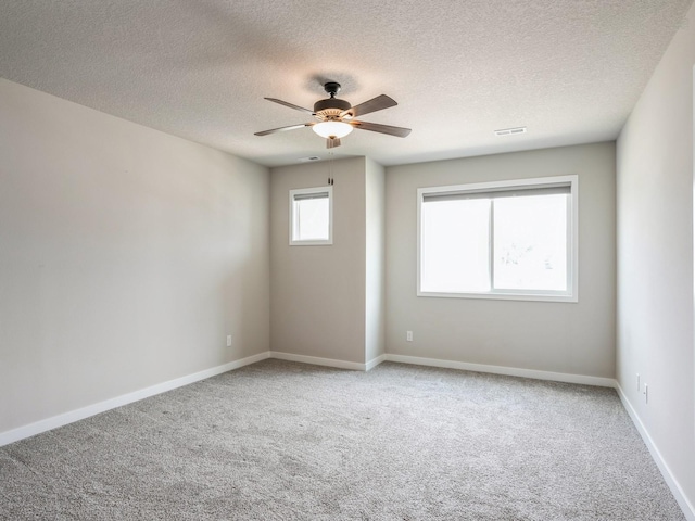 empty room featuring carpet floors, a textured ceiling, and ceiling fan