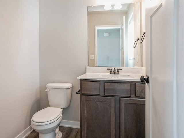 bathroom with vanity, hardwood / wood-style floors, and toilet