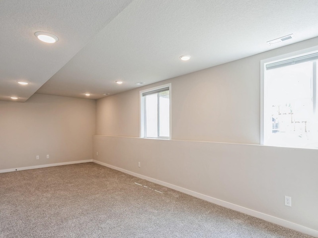 empty room featuring carpet flooring and a textured ceiling