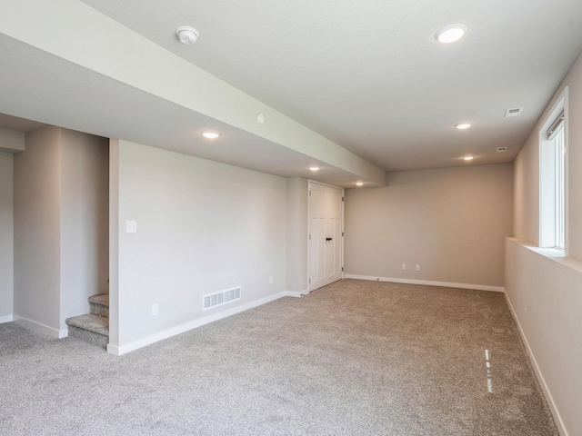 basement featuring light carpet