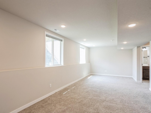 basement with carpet floors and a textured ceiling