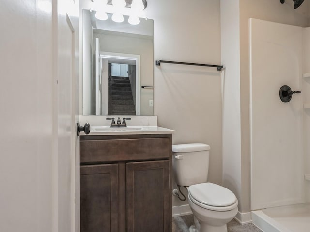 bathroom with vanity, toilet, and walk in shower