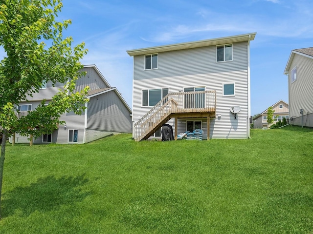 back of house featuring a wooden deck and a yard