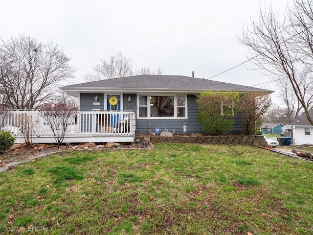 ranch-style house featuring a front yard and a deck