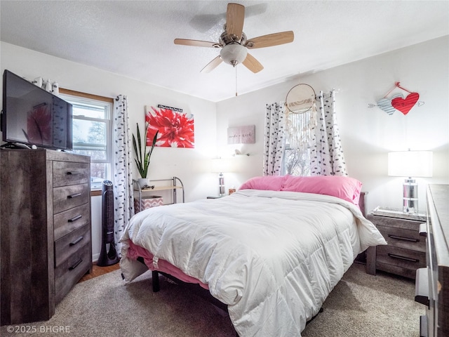 bedroom with ceiling fan and a textured ceiling