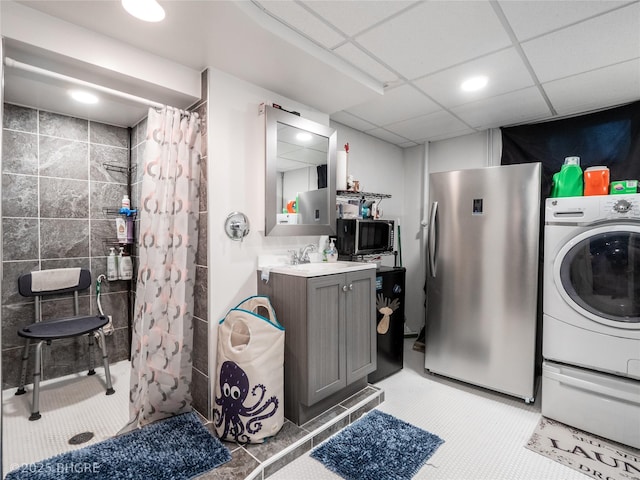 clothes washing area featuring washer / dryer and sink