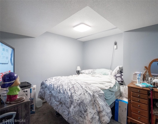 bedroom with carpet and a textured ceiling