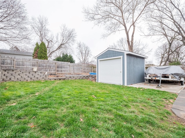 view of yard with a garage and an outbuilding