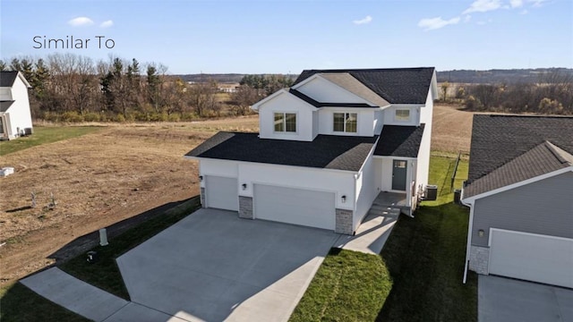 exterior space featuring stone siding, central AC, and concrete driveway