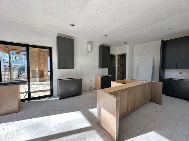 kitchen with a textured ceiling and a center island