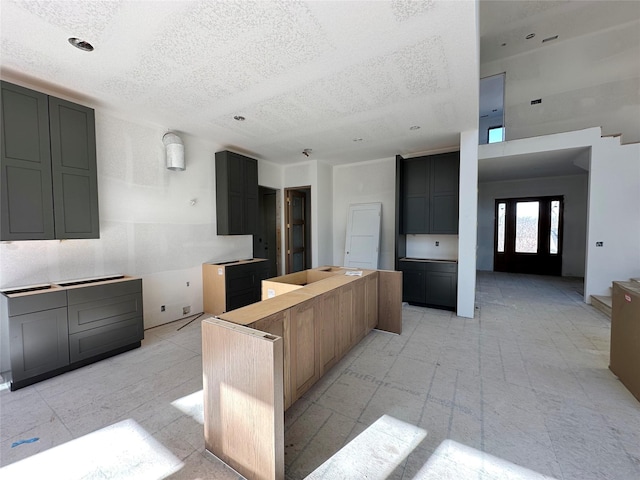 kitchen featuring a kitchen island and a textured ceiling