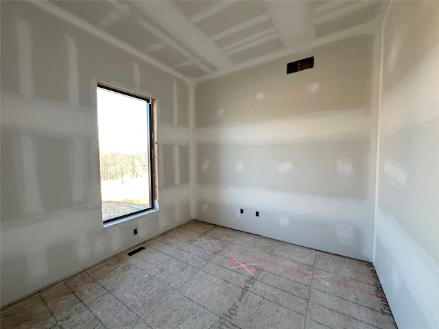 unfurnished room with visible vents