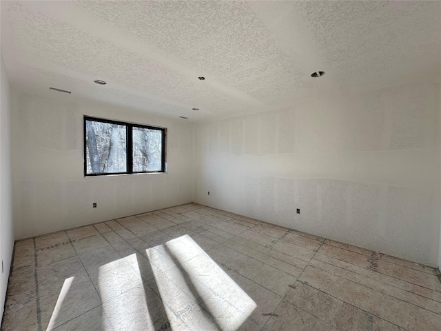 spare room featuring a textured ceiling