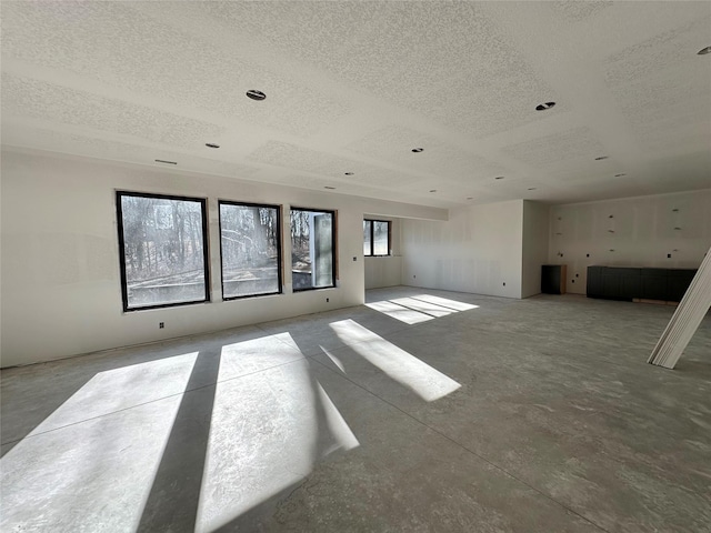 unfurnished living room with a textured ceiling