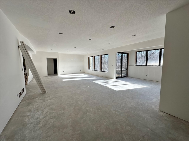 empty room featuring concrete floors and a textured ceiling