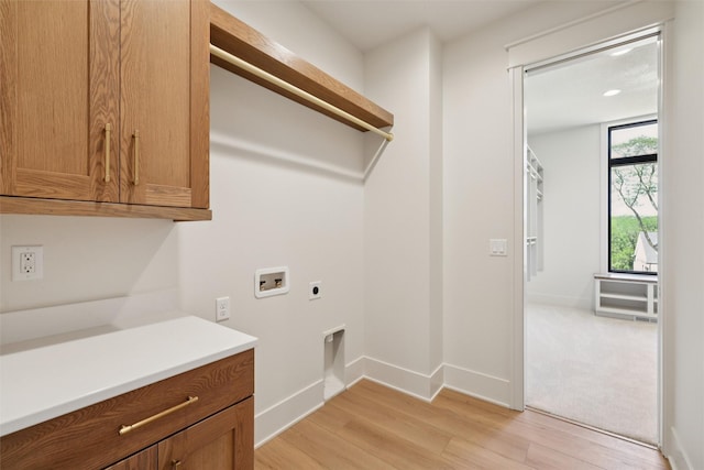 10430 Thorne Dr, West Des Moines, IA 50266 - laundry area featuring hookup for a washing machine, hookup for an electric dryer, light wood-style floors, and cabinet space