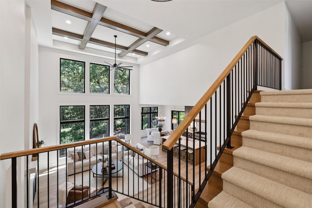 10430 Thorne Dr, West Des Moines, IA 50266 - stairs with ceiling fan, coffered ceiling, beamed ceiling, wood finished floors, and a high ceiling