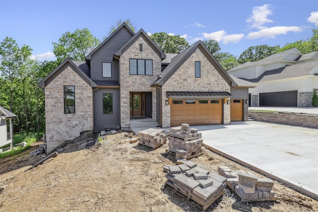 10430 Thorne Dr, West Des Moines, IA 50266 - view of front of house featuring driveway, a garage, and stone siding