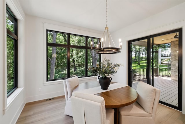 10430 Thorne Dr, West Des Moines, IA 50266 - dining area with a chandelier and light wood-type flooring