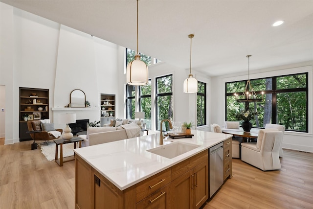 10430 Thorne Dr, West Des Moines, IA 50266 - kitchen featuring brown cabinets, dishwasher, healthy amount of natural light, light wood-style floors, and recessed lighting