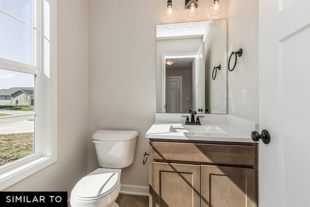 bathroom featuring vanity and toilet