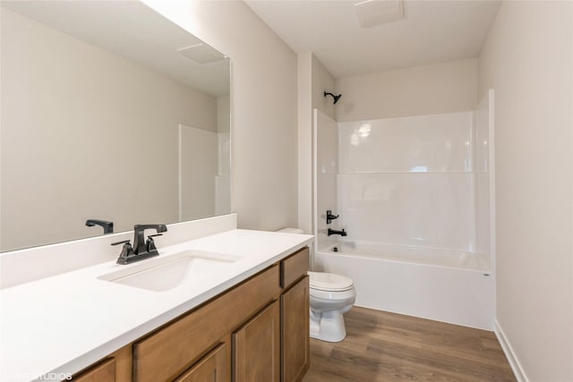 full bath featuring toilet, shower / washtub combination, wood finished floors, and vanity