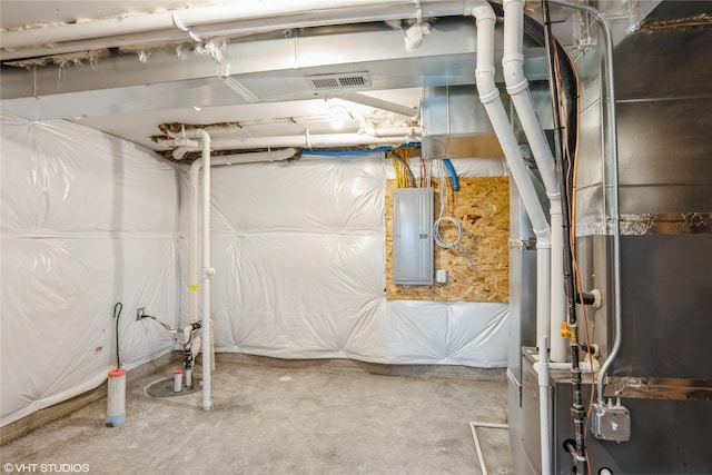 unfinished basement with visible vents, heating unit, and electric panel