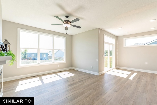 spare room featuring ceiling fan and light wood-type flooring