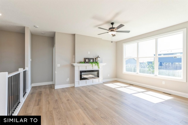 unfurnished living room with light hardwood / wood-style floors and ceiling fan