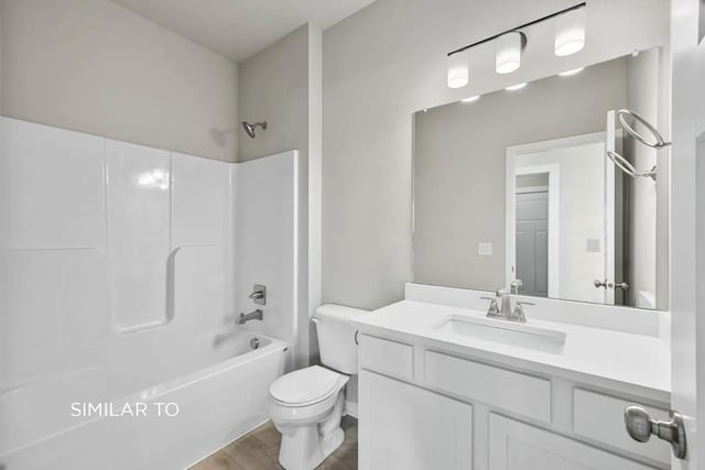 full bathroom with vanity, hardwood / wood-style flooring, bathing tub / shower combination, and toilet