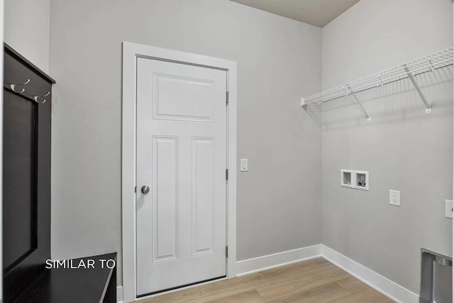 laundry room with washer hookup and light hardwood / wood-style floors