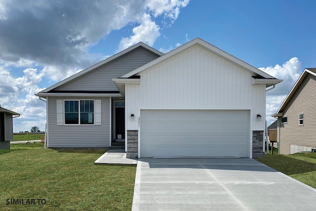 view of front of house featuring a garage and a front lawn